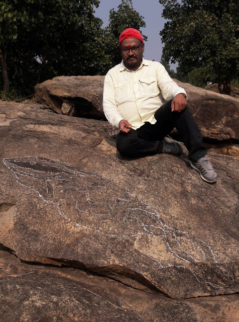 Archeologist, Pandit Anoop Kumar Bajpai posed with  his recent discovery of Fossil of 300 million years old giant fish
