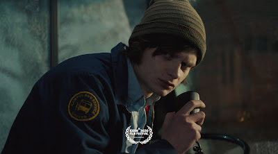 Michael (Charlie Tahan) aimlessly drives a college bus in a still for the film "Drunk Bus" (2020).