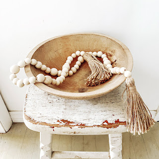 wood bead garland in wood bowl