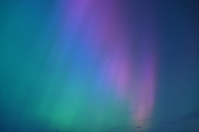 A green, indigo and pink sky