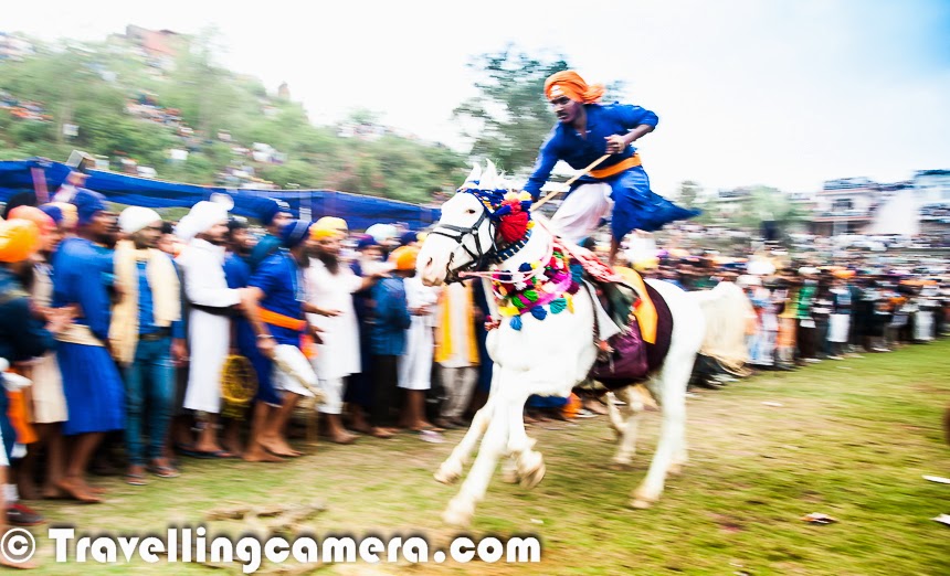 Few weeks back one of my friends pinged me over Facebook to ask if I can join in one of his Photography Trip during Holi. Idea was to join the group of Photographers and help them utilize the basic techniques of Photography. And when it comes to learning and travel, I am always ready. Leading a group of enthusiastic explorers and Photographers is a very good learning experience and, hence, I agreed to join the gang for Hola Mohalla 2014. This Photo Journey shares some moments from the visit to Hola Mohalla, an event that occurs every year at Anandpur Saheb, Punjab (India).We started from Delhi on 16th March at 7am in a Tempo Traveller. Ramit from 'Delhi by Foot' shared some quick facts about Hola Mohalla & its history. It was quite useful to know the background and why this event is called 'Hola Mohalla'. Here is a summary -- Sikh Guru Gobind Singh founded Khalsa at Anandpur Saheb and he asked for 5 volunteers to lead. These 5 leaders are popularly known as 'Panj Pyare'. Hola Mohalla isn't related to Holi at all, and therefore colors are hardly used here. However every year it is celebrated on same day. After a quick introduction to the place by Ramit, most of us chose to take a nap till we arrived at a place to have brunch. After a while, Roli started a conversation about photography basics. We were mainly talking about different shooting modes in DSLRs and what should be used when & associated subjectivity of choice. Apart from Photography we touched upon Softwares & Literature as well :). Jona also heard some of our conversations and planned to join us. By this time, most of the folks were sleeping.After driving for a few hours, we hit Ambala and stopped for a break. We took a 45 minutes break here and enjoyed tandoori paranthas and some pakoras with tea. It was time to refill fuel tank and move ahead towards our destination, Anandpur Saheb. We bypassed Chandigarh and took the shortcut which hits Kharar via Greater Mohali area. Roads near Anandpur town were badly jammed with trucks, karts, buses, cars & bikes. It seemed that whole of Punjab has come to the town for Hola Mohalla Fair. We had to spend approximately an hour in this traffic jam and then we got to know that Punjab chief minister was visiting, which was the main reason for stopping the incoming traffic.We had booked a hotel called 'Simran' with very basic facilities. It seems that Anadpur Saheb had only a handful of hotels because during normal time, one can stay in Gurudwara. Guradwara has sufficient arrangements to accommodate hundreds of folks at any point in time. So there is not much demand for hotels in Anandpur Saheb. The streets were full of people and there were tens and thousands of Sikhs there. After having some rest at the hotel, all of us headed towards to the ground where Nihang Warriors were showcasing their skills to public.We encountered few langars on the way, where Jalebi, Pakoras and food was being served. Before hitting the main ground, we thought of having something at the Langar. We had to put off our shoes before entering into the langar areas and also got to know that everyone of us needed to cover our heads. Everyone had something to cover the head except me and Madhu. There were various shops nearby to buy stuff, Initially it looked quite odd and lot of questions were coming to my mind. I was not able to relate to things which were communicated by leaders on stage and I was wondering about existence of such community in country like India. I was not able to control myself and thought of talking to the Nihang singhs sitting around the corner of main stage. Asked various questions and the way he replied made me feel a bit relieved. Especially when I asked - 'Are you ever tempted to use your weapon wielding skills when you get angry or not in right state of mind', he replied this in detail. It seems that training grounds are there in almost every town where Sikhs are living. They go to these training centers called as Akharas and before the actual training starts, each of them is trained by Jathedar (leader/coach) about ethics of using these weapons and related skills. As a basic principle, no one of them can use these weapons without permission of their guru, except one of the situations. And another thing is that using these weapons for  personal use is restricted. If someone is found using the skills and weapons in undesired way, the community has defined appropriate punishment. More than all these details, I loved the way this guy was explaining all these things to me. Now I was confident that all this is happening for some reasons which this community experiences over time and it;s harmless for overall Eco-system. In fact, I found this a very good way to be united and teach youth about some of the religious values. Whole evening was full of action, music, poets and Khalsa stories. Some parts were boring,  but overall the action filled activities by different groups from various parts of the country were definitely worth experiencing. Some of their leaders and sponsors had come for Hola mohalla from different countries. Apart from demonstrating these skills, few other games are organized during these two days of Hola Mohalla. We had also planned to go for Kabaddi & kho-kho but couldn't find time for that. It seems polo is also played in one of the grounds in Anadpur Saheb during Hola Mohalla. All these events keep happening throughout the night. Some of us moved for dinner at around 9pm and also left at around 10:30pm. Again we preferred to have dinner at Langars only. After dinner, we moved towards Anandpur Saheb market which was full of people moving towards main Gurudwara. We couldn't visit the Gurudwara during these two days because there was significant waiting time involved to reach inside and we were only there for a very short while. We found a sweets shop, had some besan barfi and moved back to our hotel to have some rest and gear up for the most exciting day - Hola Mohalla. While going back towards the hotel, we noticed that most of the folks around these grounds were sleeping in tempos/trucks they had arrived in. Activities were still on at around 11:30pm and many of the folks were sitting on top of buses & trucks to have a clear view. Next day started with delicious breakfast at hotel and then we moved towards Gurudwara campus where various processions go from main Gurudwara to Sheeshganj Gurudwara. While going towards Gurudwara, Ramit took us to a ground full of swings and maut-ka-kuan. All of us watached Maut-ka-Kuan show, which was awesome. Some of us chose to have some snacks and then we moved towards Gurudwara. It was very crowded and at times it was getting difficult to move.Smoking and drinking is strictly prohibited in Anandpur saheb and there is no liquor shop in this town, but bhang was available at every 100 meters in different forms.We kept walking and it was hot outside. There was hardly any action in the market before noon. There were lots of people but hardly anything was happening. Processions were yet to start. Some of us were tired and wanted to get under shade. We chose to have lunch and take some rest.It was quite an experience to walk around these markets in Hola Mohalla fair. While walking around the streets, I observed a very interesting thing. The foreground, where all groups had to gather was occupied by significant numbers of bikes. There were 6-8 policemen who had to ensure that ground gets empty soon to avoid chaotic situation. One of the policemen approached boys and requested them to do some 'seva' by moving these bikes on one side of the road to create a queue. And it was amazing to see a group of 15-20 young boys clearing the space in few minutes. I was super impressed with this act by youth at Hola Mohalla. Then we thought of moving towards the main ground where Hola Mohalla is celebrated in presence of all Nihang singhs and folks from different parts of the country.The above photograph gives a quick glimpse of the main ground where Hola Mohalla is celebrated. This was less than 1% of the crowd around this ground. Folks were settling down and there was not much action when we reached main ground. Still people were coming in and real action was yet to start. Some of the Nihang groups were performing in the middle of this huge ground. I was a bit disappointed by the fact that performances were hardly visible to people sitting on surrounding hills, because many of the folks including media & photographers had surrounded these performers from all the sides. I am sure that folks sitting at a distance would have major difficulties in watching the action happening on ground.Some of the bikers started showing stunts on Hola Mohalla ground znow horses, camels, elephants had started coming in. Final evening on the day of Holi festival is considered as main Hola Mohalla, when real action happens. Horse ride is one of the popular sport of Hola Mohalla. Some of the folks were riding on 4 horses as well. During this race, grass bundles are put in the middle of the ground and these riders have to pick a bundle with a stick when they were racing at a very high speed. It was crazy to see that people had created a narrow lane around the place where these horses run. There is no boundary defined for this race, which means that horses can easily hit folks standing on both sides. Initially I was very uncomfortable going to the front and some photographs and then Ramit encouraged me to go & experience something very special. During this many people step over each other and situation may get chaotic and everything during this time happens instantaneously.This Holi was the most unique one for me. And Hola Mohalla is an event worth experiencing at least once. The warmth and large-heartedness of Sikhs shines through the frenzied activities and unbelievable crowds. A visit to Hola Mohalla can help in getting to know the Sikh culture more closely. Thanks for Ramit, Delhi by Foot & all participants for great company during this exploration !