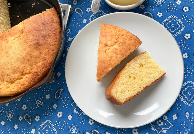 Food Lust People Love: This cheesy skillet cornbread has a crunchy bottom and a tender cheesy crumb. It is the perfect accompaniment to your favorite soup or barbecue meal!