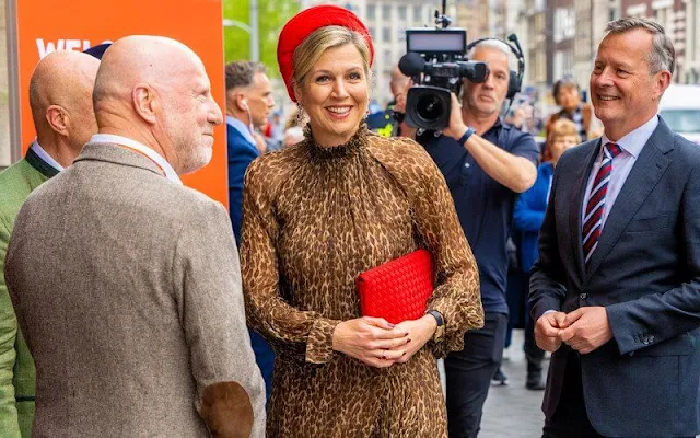 Queen Maxima wore a Debora leopard print midi dress by Natan. Natan red pumps and Natan clutch bag. Red hat