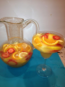 A large pitcher of white wine sangria with fruit
