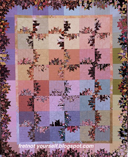 Scrap quilt using black background florals and solid pastels.