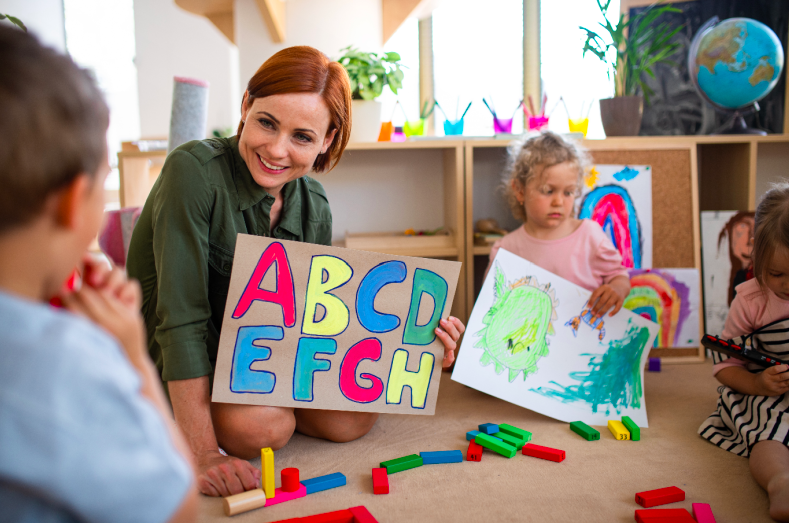 teacher holding up the alphabet