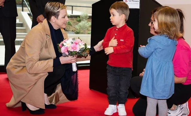Princess Charlene wore a camel emotion belted hair trench coat by Akris. Testimonio creche in the Elsa Tower