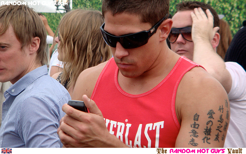 It's a Random Hot Guy guy using a mobile or cellphone