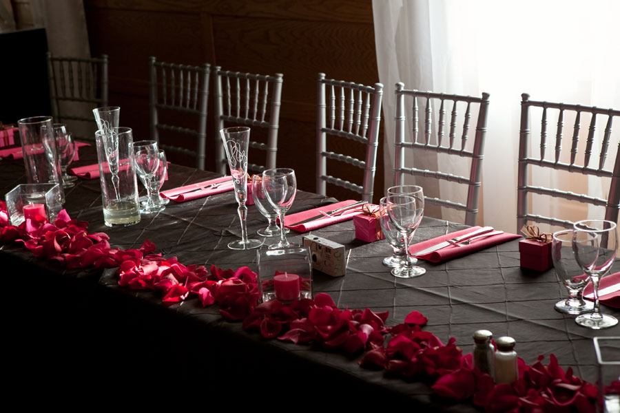 Black pintuck table cloth pink napkins rose petals with votive candles