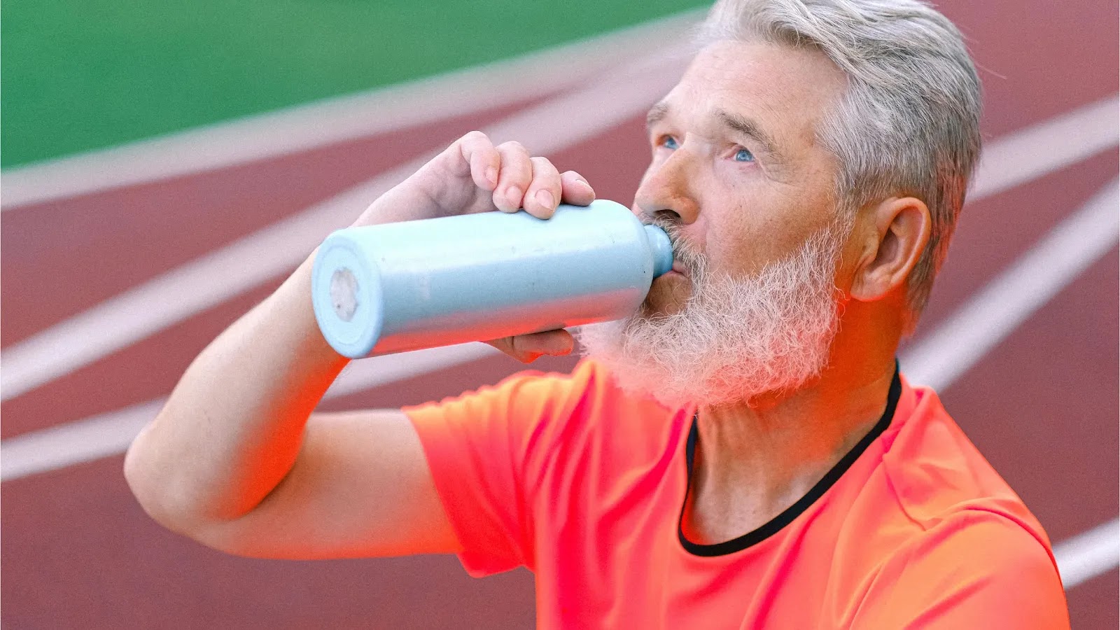 Green Eats Daily - Man Drinking Water on Track