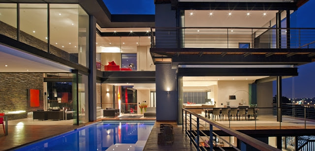 Picture of large modern mansion as seen from the pool area