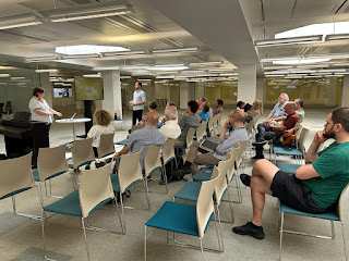 image of speakers presenting to the audience