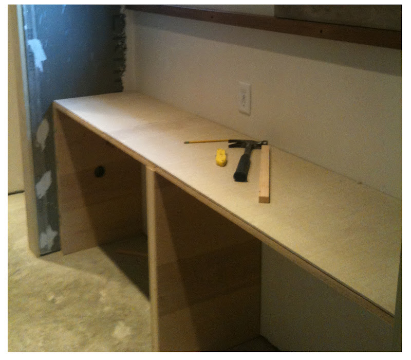 First, we built a vanity out of plywood and installed a cement  title=