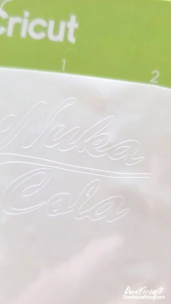 Step 3: White Vinyl  While the red paint is drying, cut out the Nuka Cola logo with the Cricut out of white adhesive vinyl.