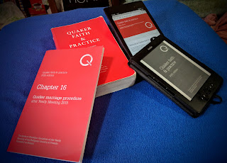 A paper copy of Quaker Faith & Practice (not most recent edition), a paper copy of the update Chapter 16 (Quaker Marriage Procedure), Kindle e-reader showing the Kindle edition of the book, and a tablet showing the web version.