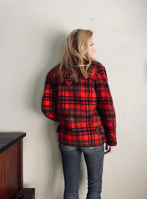Back of a woman wearing a vintage wool plaid jacket
