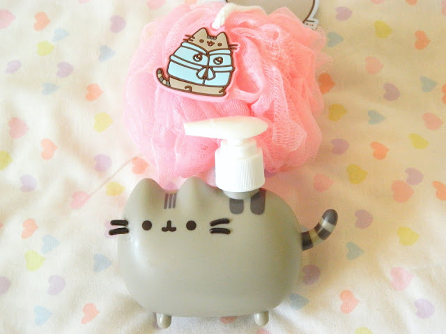 A photo showing two items from the Pusheen Box Autumn 2018, a loofah and a soap dispenser 