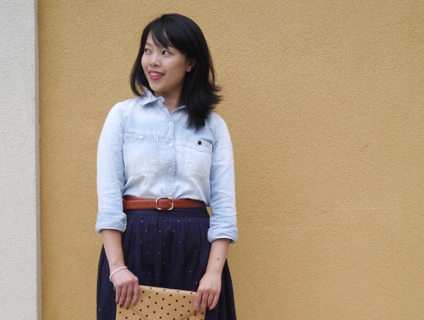 Vancouver blogger Lisa Wong of Solo Lisa wears a Madewell chambray shirt and cognac leather booties, J. Crew cognac leather belt and polka dot invitation clutch, Chinti and Parker skirt from Vancouver boutique Oliver and Lilly's, and a silver charm bracelet from Birks.