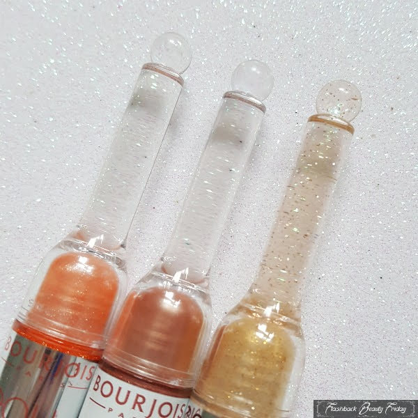 transparent wand lids of retro lipgloss with coloured dome