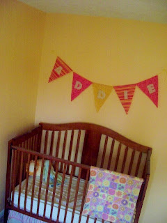 Addie bunting above the crib in the nursery