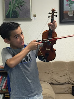 student uses violin and bow to shoot like an arrow