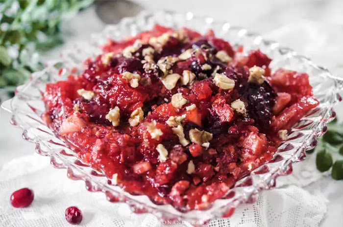 Cranberry Apple Jell-o Salad topped with walnuts to accompany Thanksgiving dinner.