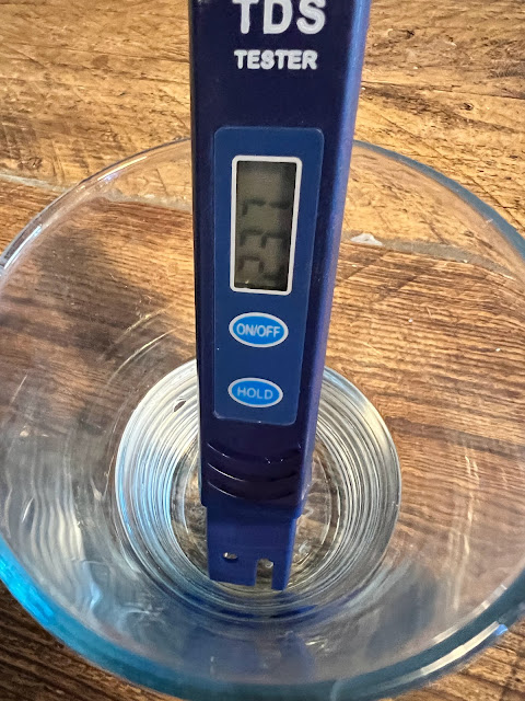 Zerowater TDS meter in glass of tap water