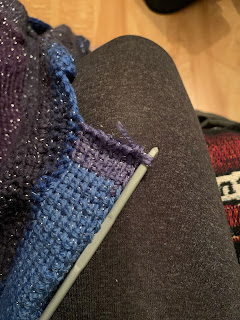 In progress, the neckband and hook with only a short tail of yarn left.