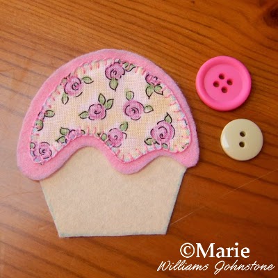 Pale pink and green button findings and a cup cake design in felt and fabric