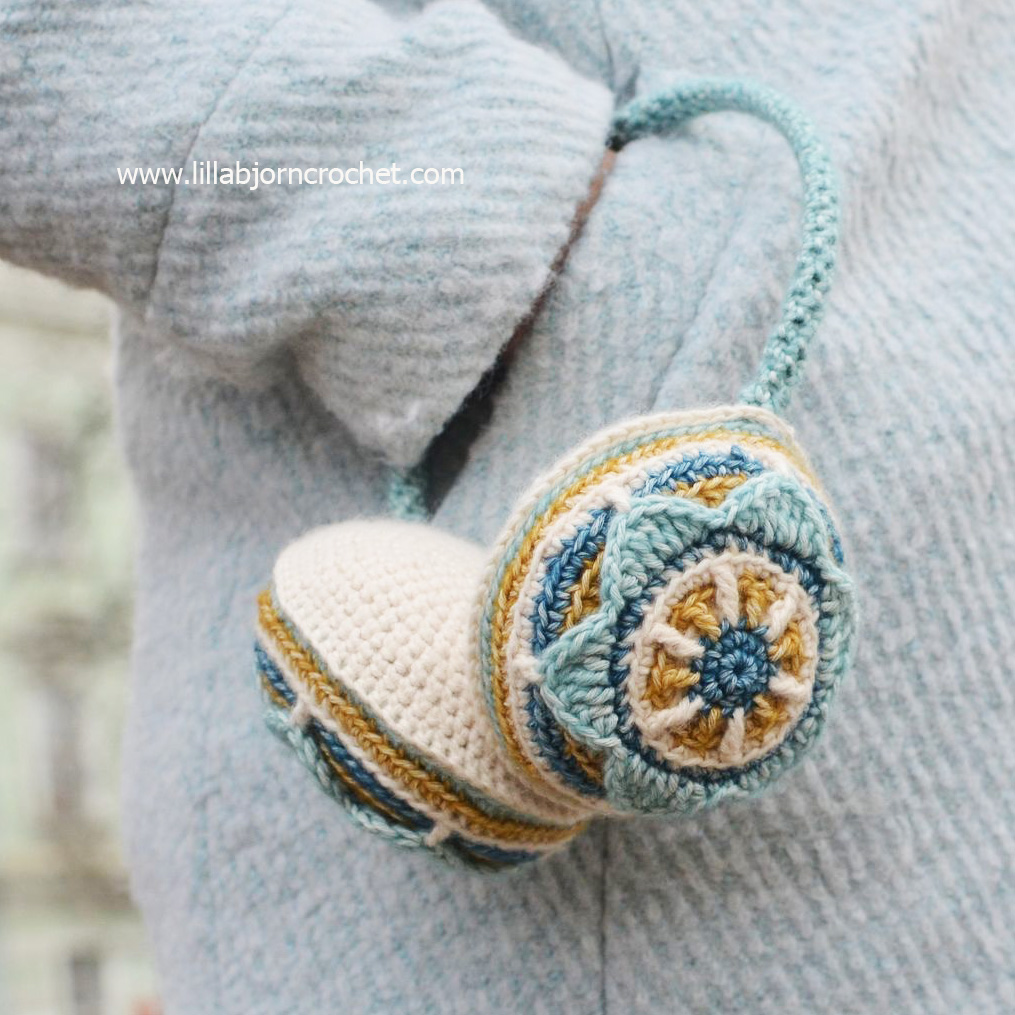 Crocheted ear muffs with flower. Designed by Lilla Bjorn Crochet - overlay crochet