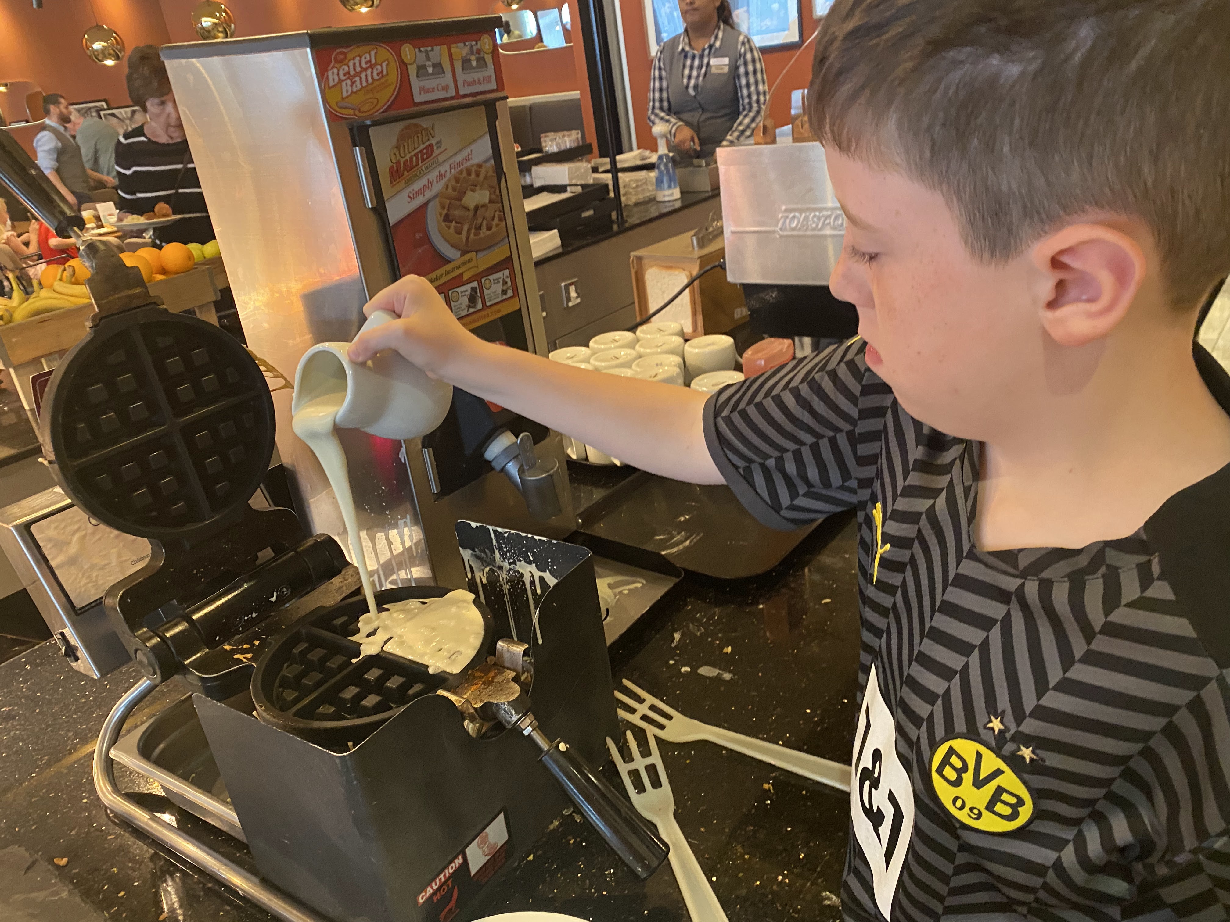 boy making waffles at Hilton Garden Inn