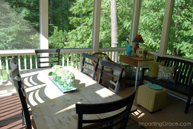 Second-story screened porch is nestled in the trees and offers a shady spot for relaxing.