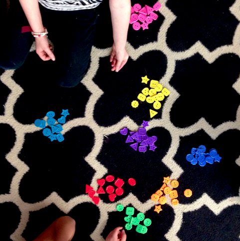 kindergarten students sorting buttons