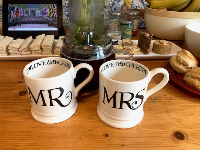 Emma Bridgewater Mr and Mrs mugs with an afternoon tea spread in the background