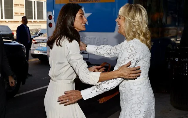 Queen Letizia wore a new Dakota crepe shirtdress by Ralph Lauren Collection. First Lady Jill Biden wore a white lace dress