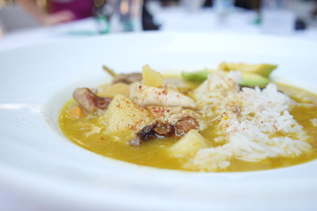 Sancocho with long grain rice and fresh avocado.