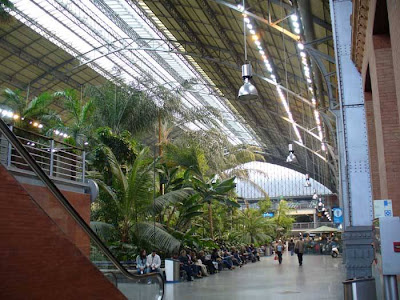 Madrid Atocha (Spanish: Estación de Madrid Atocha, also named Madrid Puerta de Atocha) is the largest railway station in Madrid. It is the primary station serving commuter trains (Cercanías), intercity and regional trains from the south, and the AVE high speed trains from Barcelona (Catalonia), Saragosse (Aragon), Seville (Andalusia) and Valencia (Levante Region). These train services are run by the Spanish national rail company, Renfe. The station is in the Atocha neighborhood of the district of Arganzuela. The original façade faces the Plaza del Emperador Carlos V, a site at which a variety of streets converge, including the Calle de Atocha, Paseo del Prado, Paseo de la Infanta Isabel, Avenida de la Ciudad de Barcelona, Calle de Méndez Álvaro, Paseo de las Delicias, Paseo de Santa María de la Cabeza, and Ronda de Atocha.