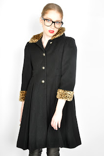 Vintage 1980's black wool baby doll shaped coat with faux leopard print fur collar and cuffs.