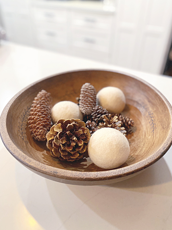bowl of pinecones and dryer balls
