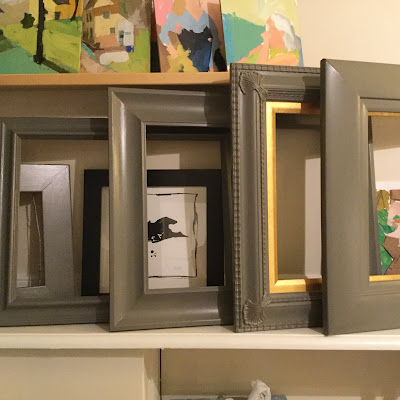 Painting old picture frames grey.