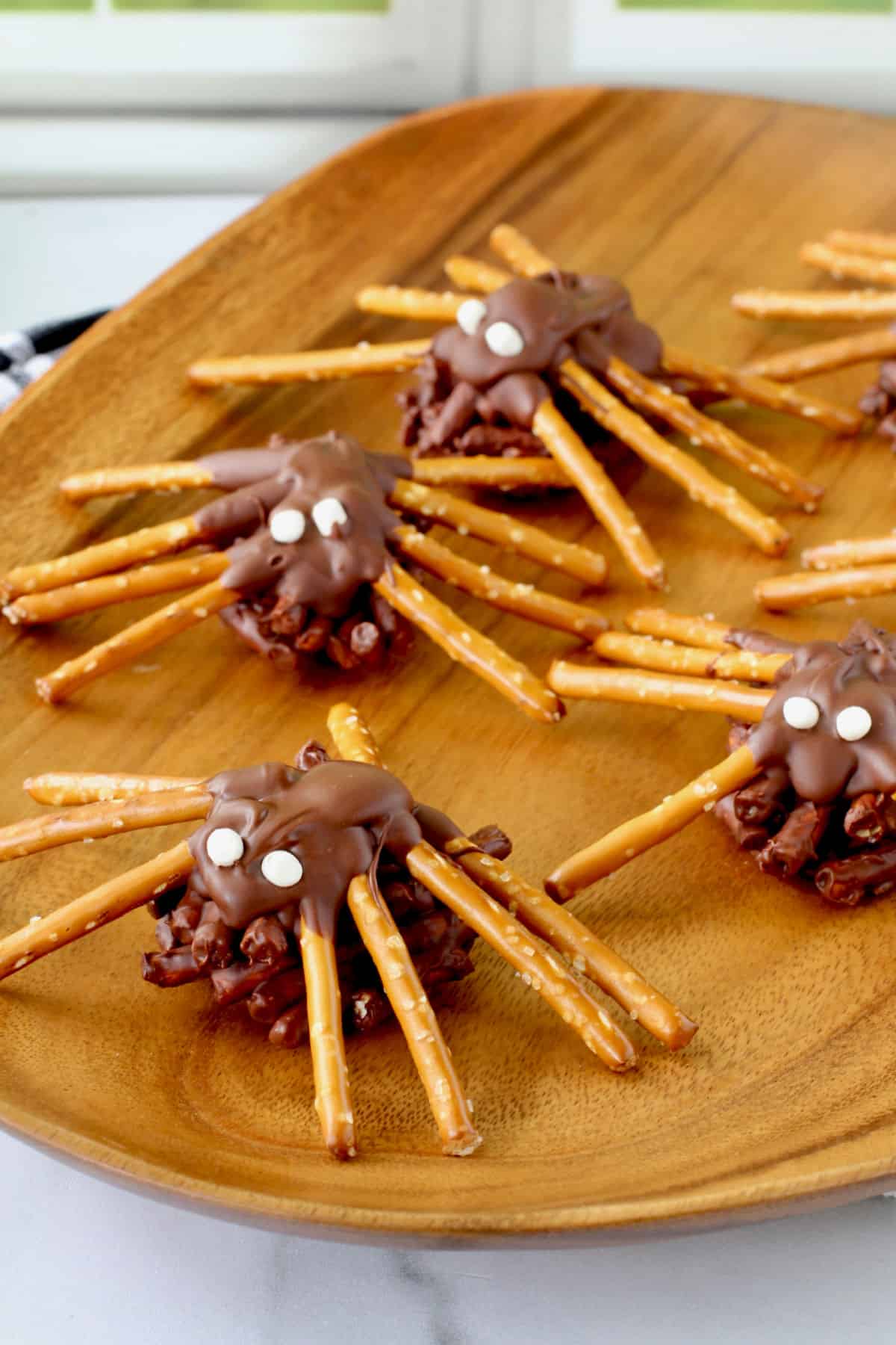 Chocolate Peanut Butter Spider Bites on a wood tray.