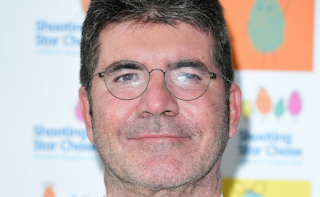 Simon Cowell stretchered out of his house and rushed to hospital by ambulance after falling down the stairs at his London home