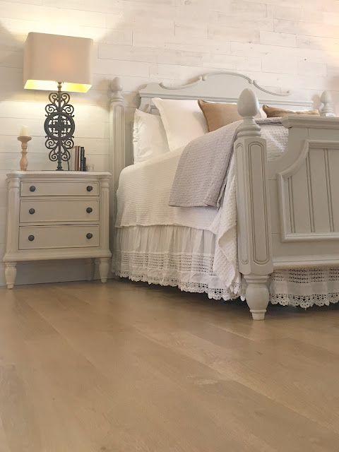 Detail of white oak hardwood floor in farmhouse style master bedroom in Hello Lovely Studio fixer upper