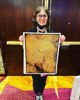 2022 - PyCon 2022 Chair Emily showing off her winnings with a piece made by K Lars Lohn