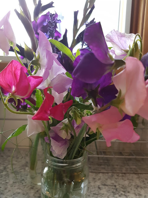 a bouquet of sweet peas in a vase