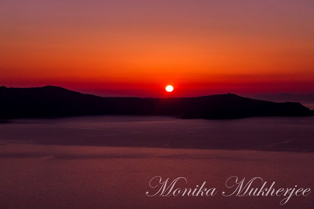 Santorini Sunset Greece by Monika Mukherjee