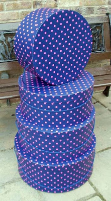 stack of blue hat boxes with pink polka dots