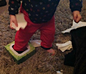 picture of a toddler with his foot in a tissue box