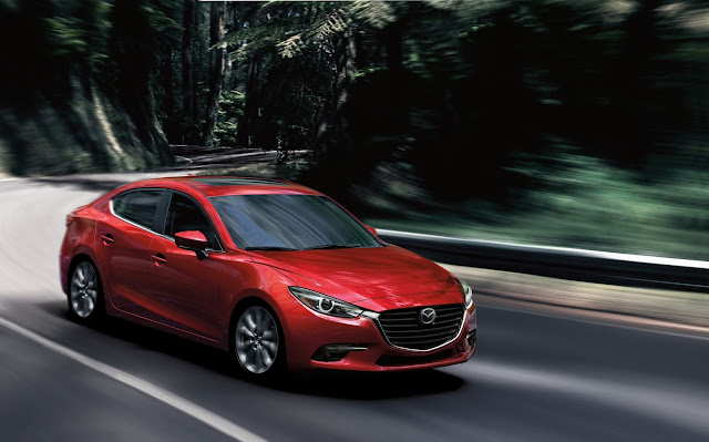 Front 3/4 view of 2018 Mazda 3 Four-Door