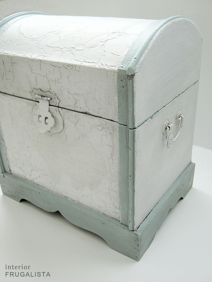A small decorative wooden trunk refreshed with white paint.